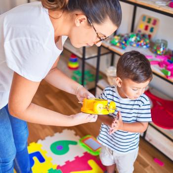 woman working with young boy