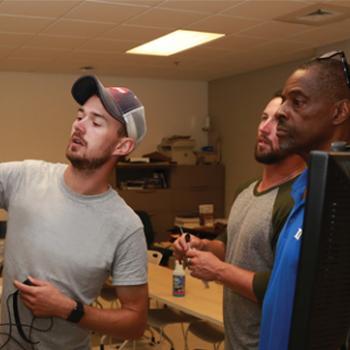 Three male students in hands-on trade program