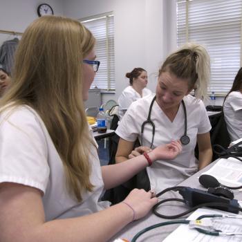 Nursing students practice taking heart rates
