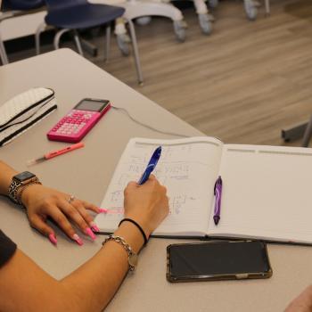 Female student writing in notebook