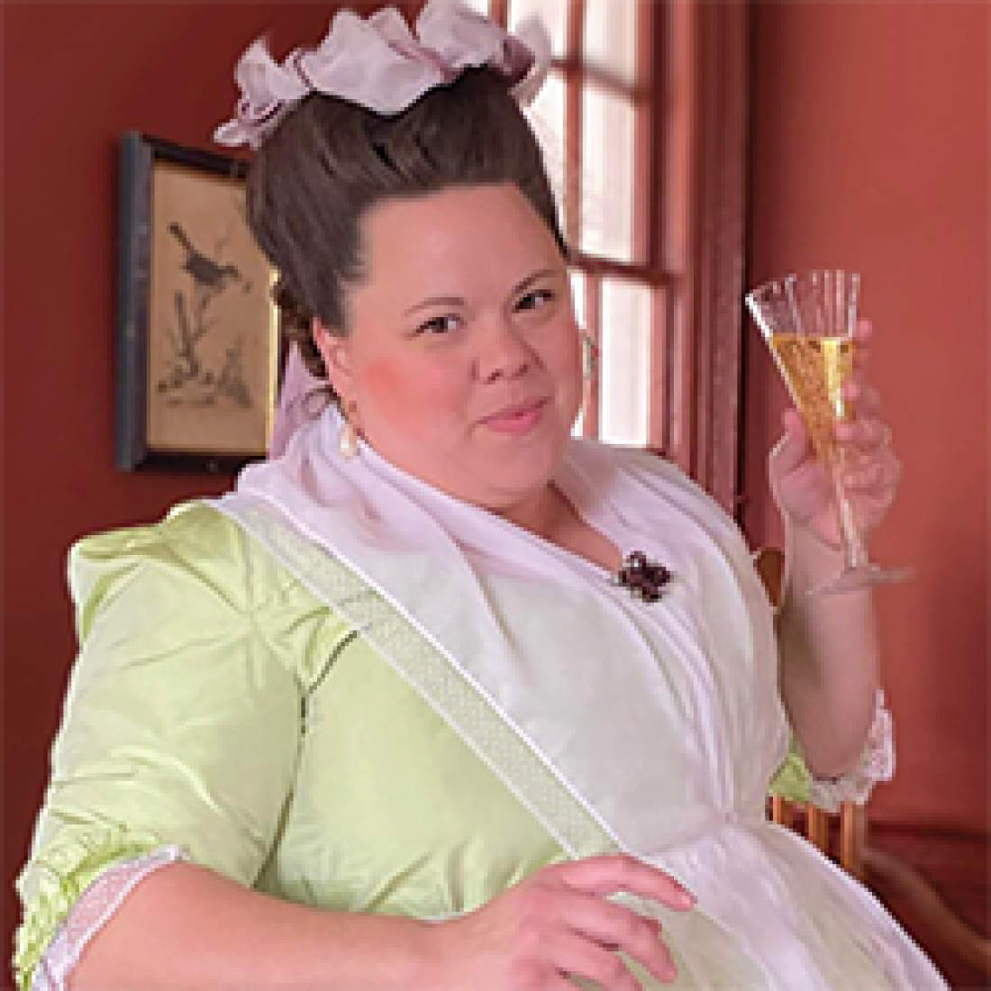 Amanda Brantly dressed as a 19th-century debutante holding a champagne flute